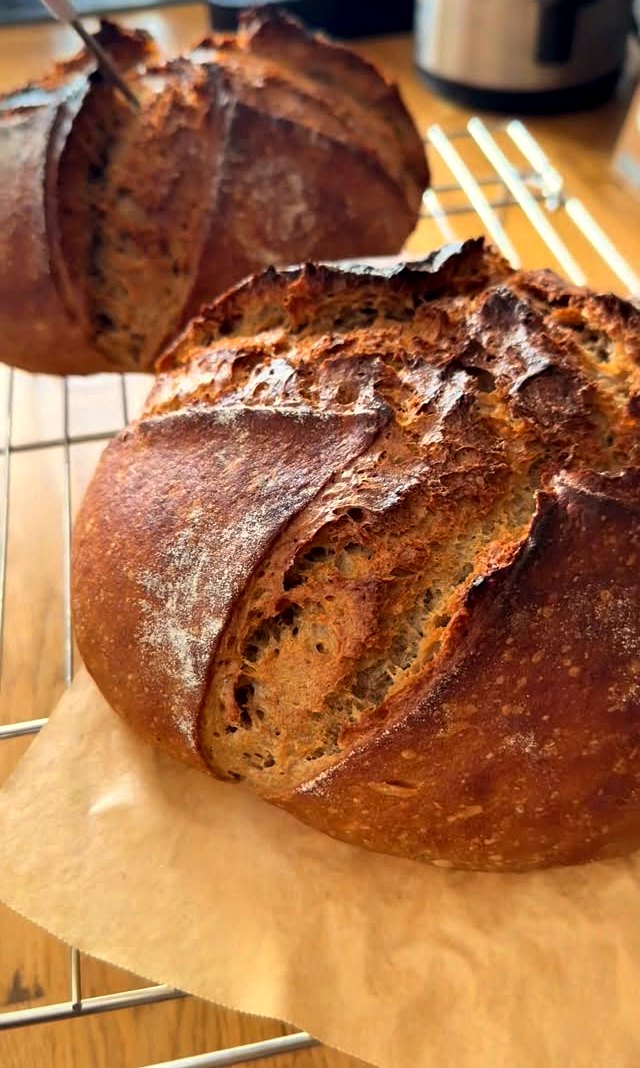 A freshly baked scored sourdough loaf